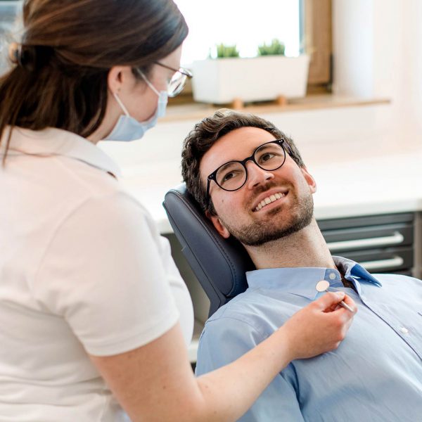 Zahnärztin behandelt einen Patienten